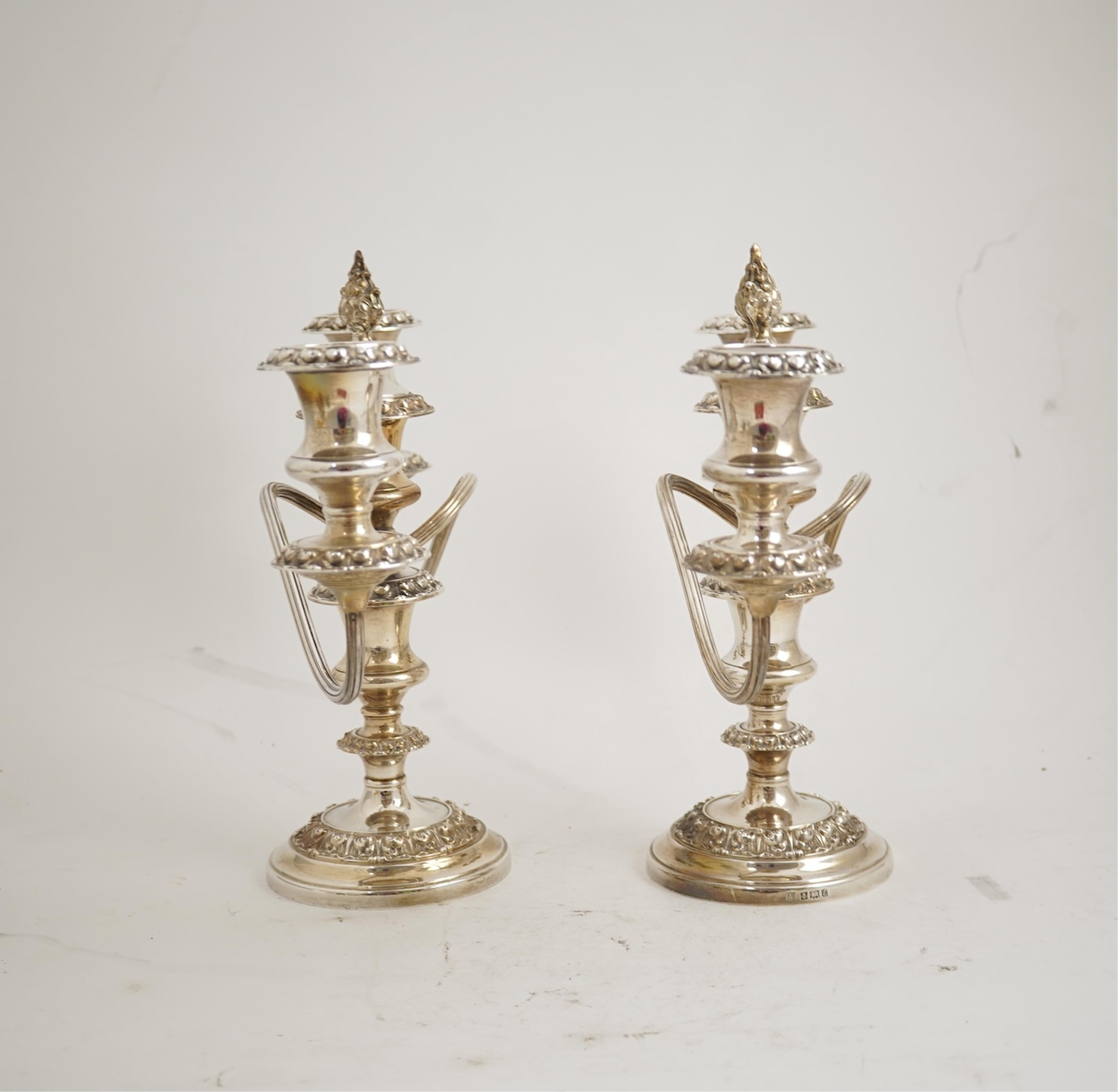 A pair of Elizabeth II silver dwarf two branch, three light candelabra by Barker Brothers Silver Co